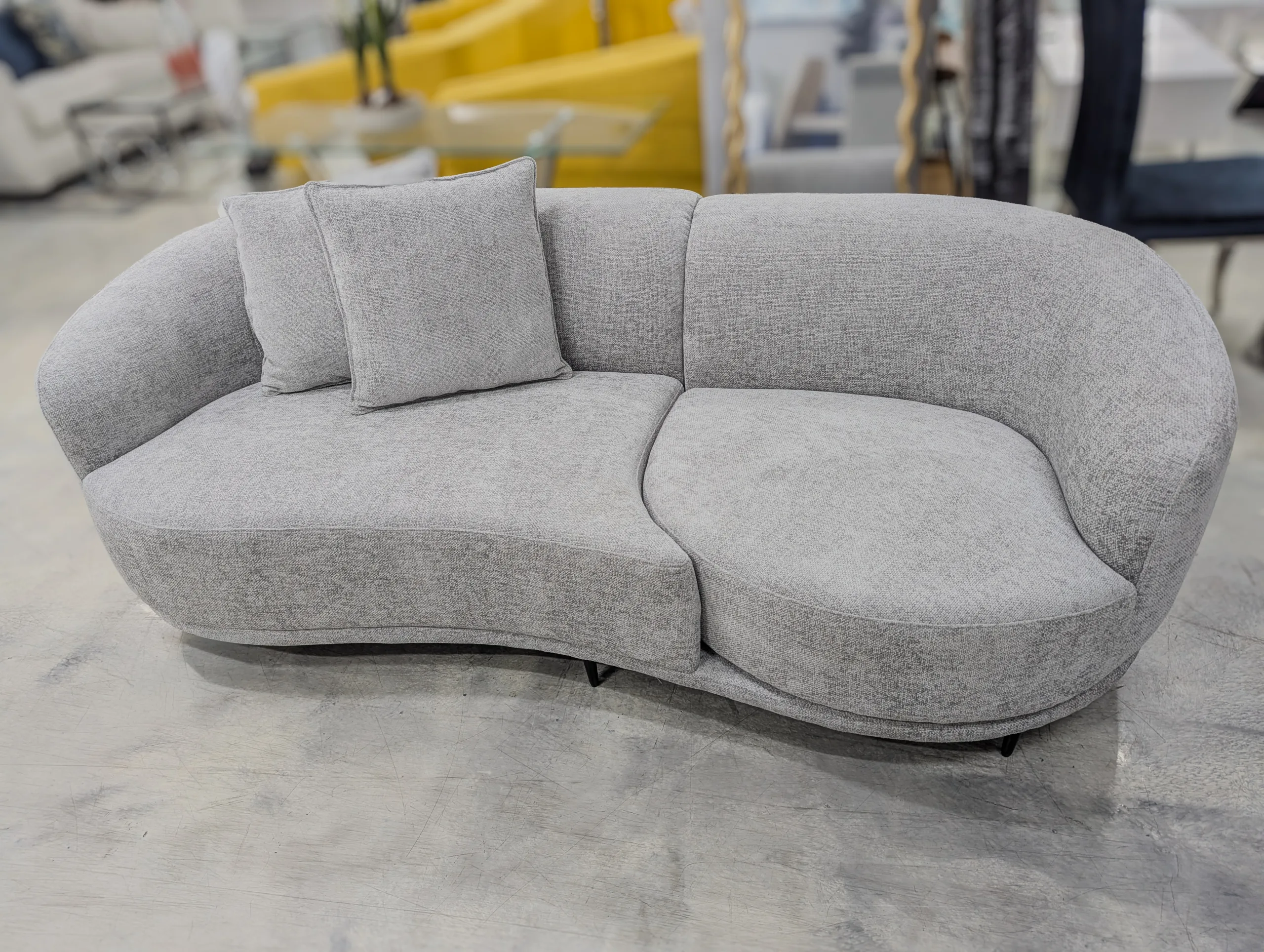 Modern Curved Sofa – Contemporary Sculptural Upholstered Couch in Light Gray with Accent Pillows